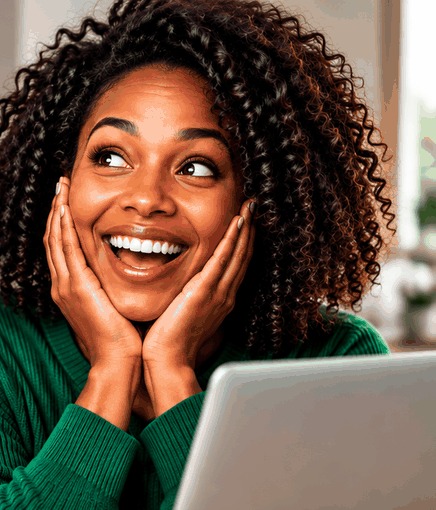 A woman delighted at what she found on her laptop